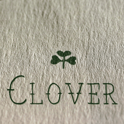 the word clover on an envelope with a clover above it