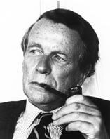Portrait of David Ogilvy, famous advertising expert smoking a pipe and looking into the distance